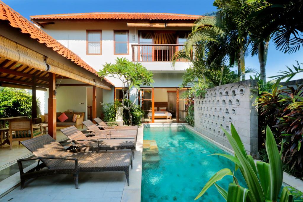 Exterior view of private pool villa with lounge chair at Ekosistem in Canggu