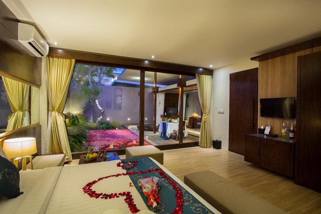 Bedroom with TV & AC at Asa Bali Luxury Villas 