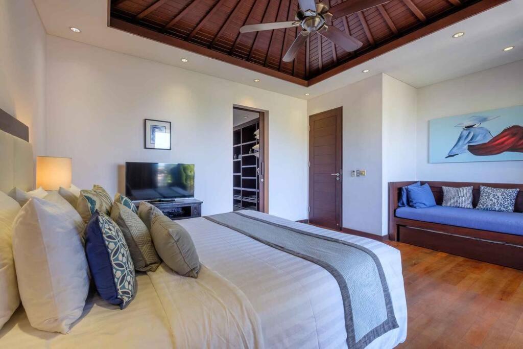 Bedroom with sofa at Beachfront Estate