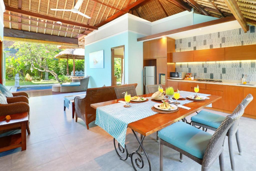 Dinning table with kitchen at Kecapi Villa