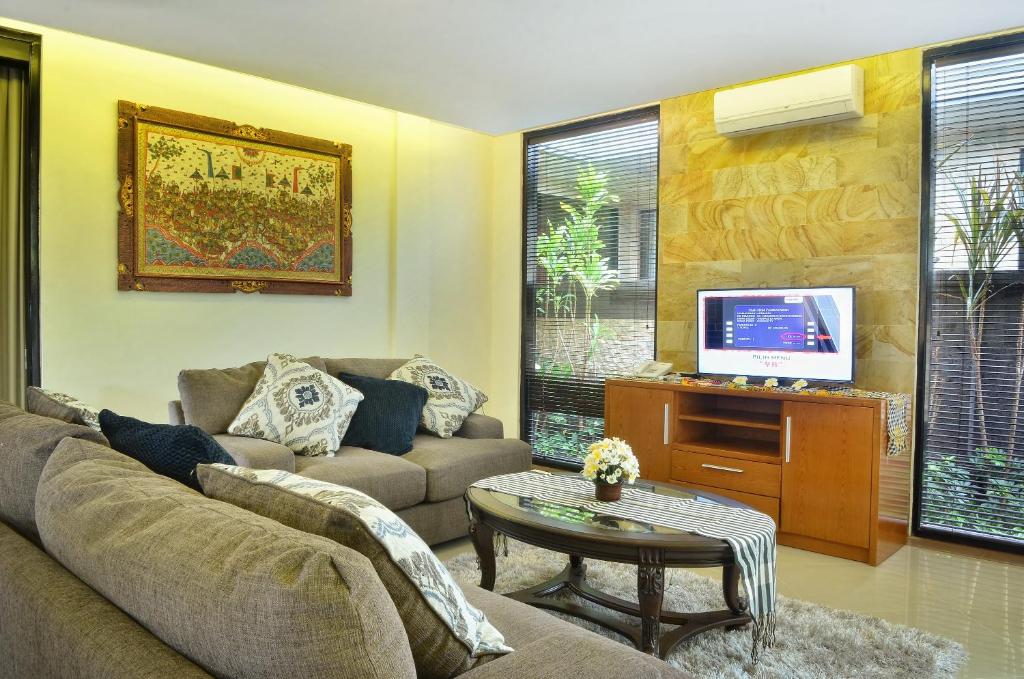 Sofa with TV at Kori Maharani Villas