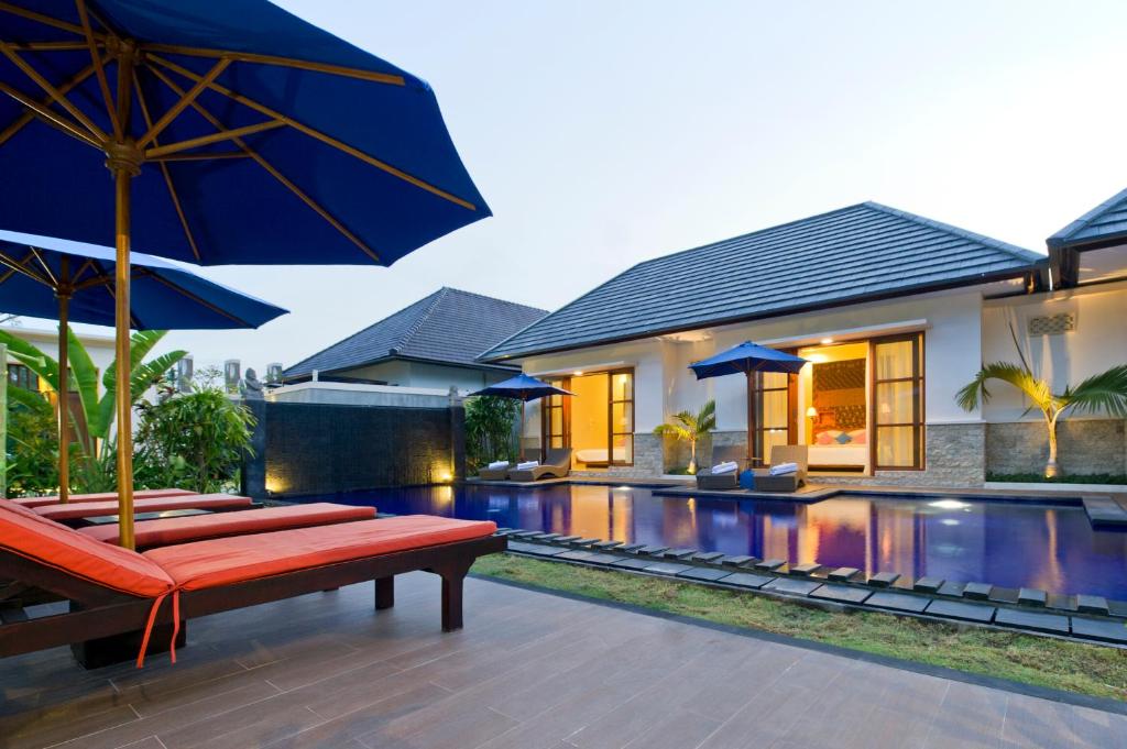 Exterior view of private pool villa with lounge chair at M Two Villas in Seminyak