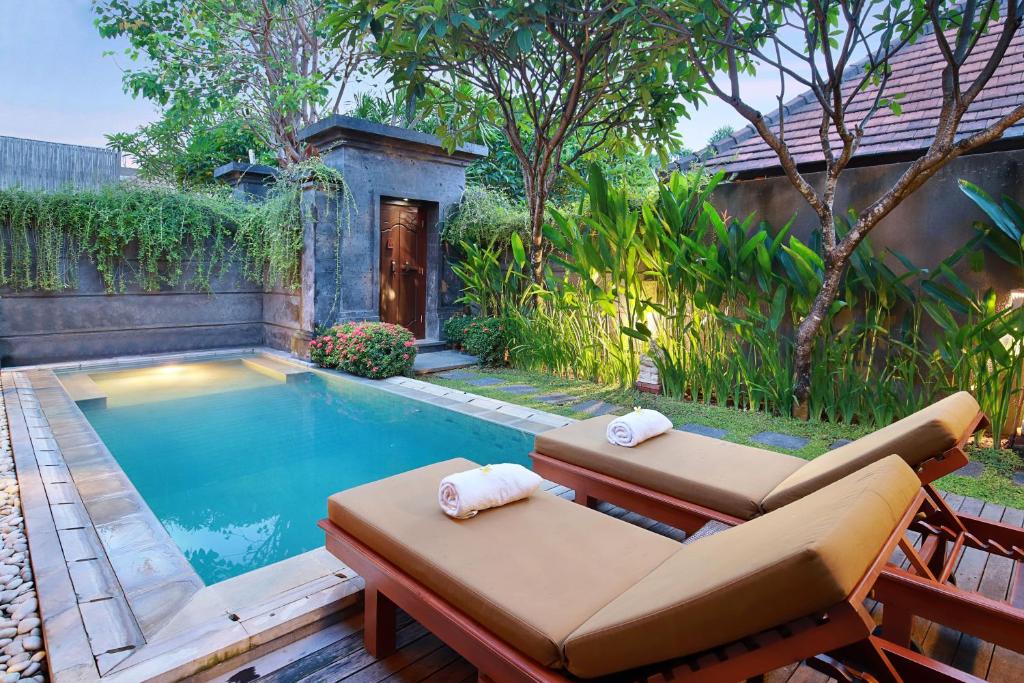 Sun loungers or beach chairs at Nyuh Bali Villas