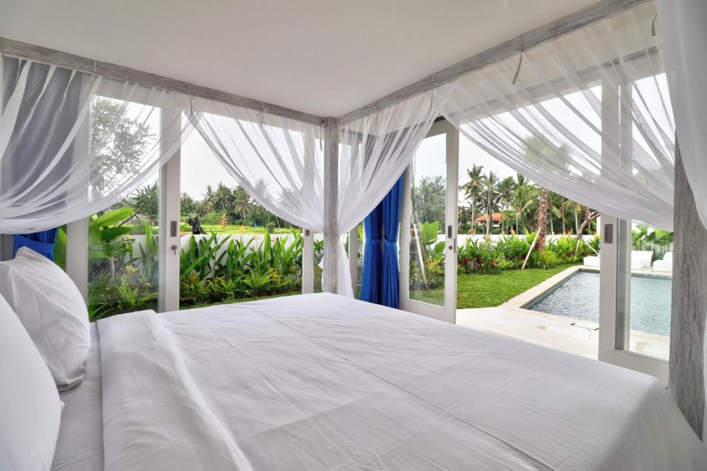 Bedroom with swimming pool at villa Tirta Padi