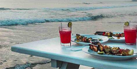 Beach dining with grilled skewers