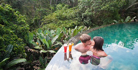 Couple kissing in villa infinity pool