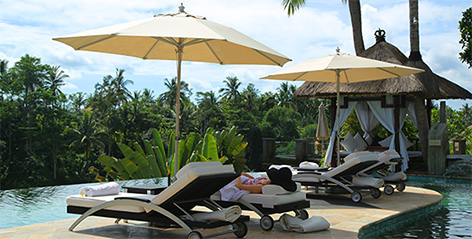 Relaxing by villa infinity pool