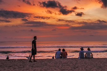Person wading in the water during sunset