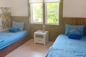 Simple hostel room with twin beds and a window