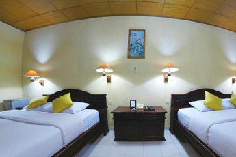 Neatly arranged double beds in a budget hotel room