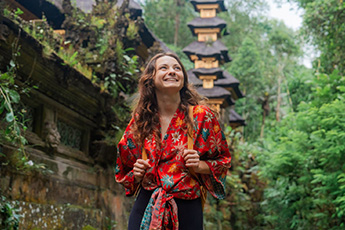 Traveler wearing red dress posing at temple