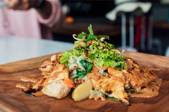 Grilled fish served with greens