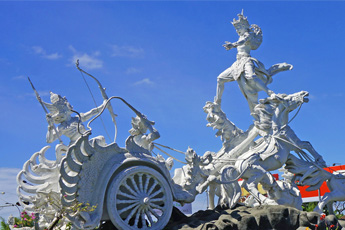 White stone statue of a horse-drawn chariot