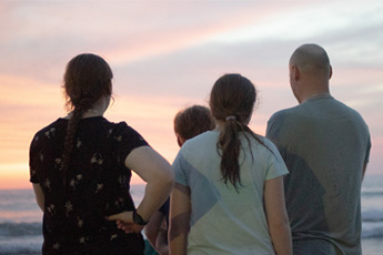 Friends enjoying sunset view on the beach