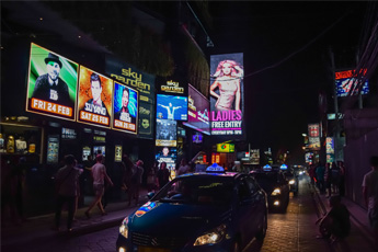 Night view of busy street with neon-lit signs
