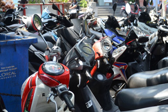 Motorbikes parked tightly in a rental area