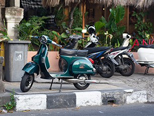 Parked scooters by the sidewalk