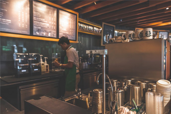 Cozy coffee shop counter with drinks and menu board