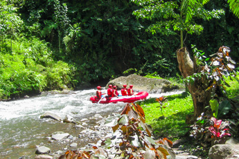 Raft with people floating down a jungle river