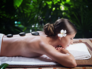 Woman receiving massage in outdoor spa
