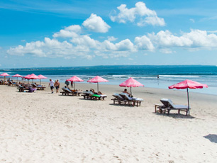 Beach with pink umbrellas and sunbeds
