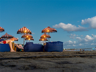 Umbrellas and bean bags set up for beach visitors