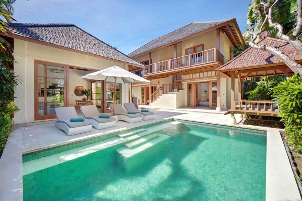 Two-story villa with poolside loungers